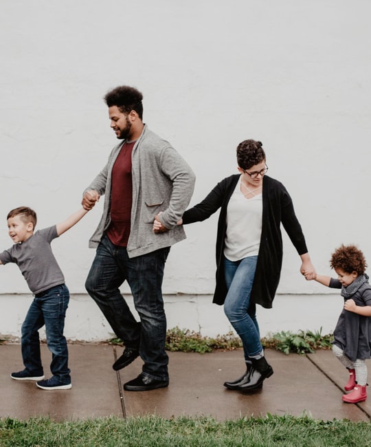 A family of four walking happily